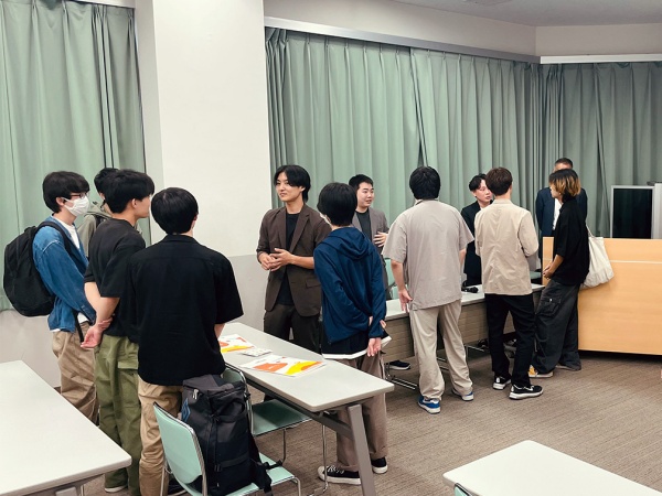 卒業生が学生たちに囲まれて質問に応じている様子